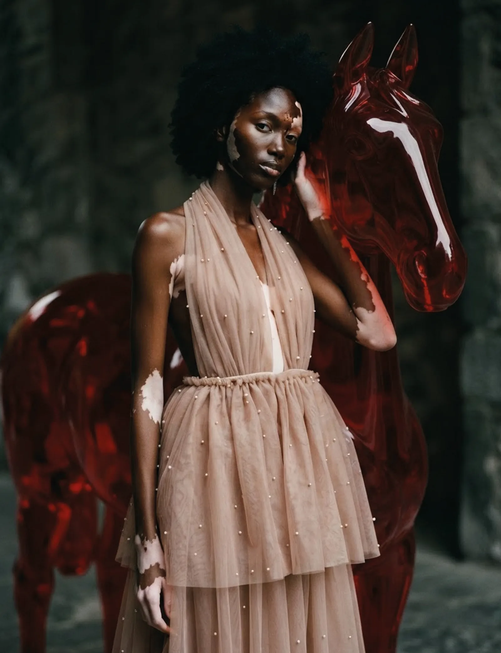 Portrait of Naima in front of the red glass horse