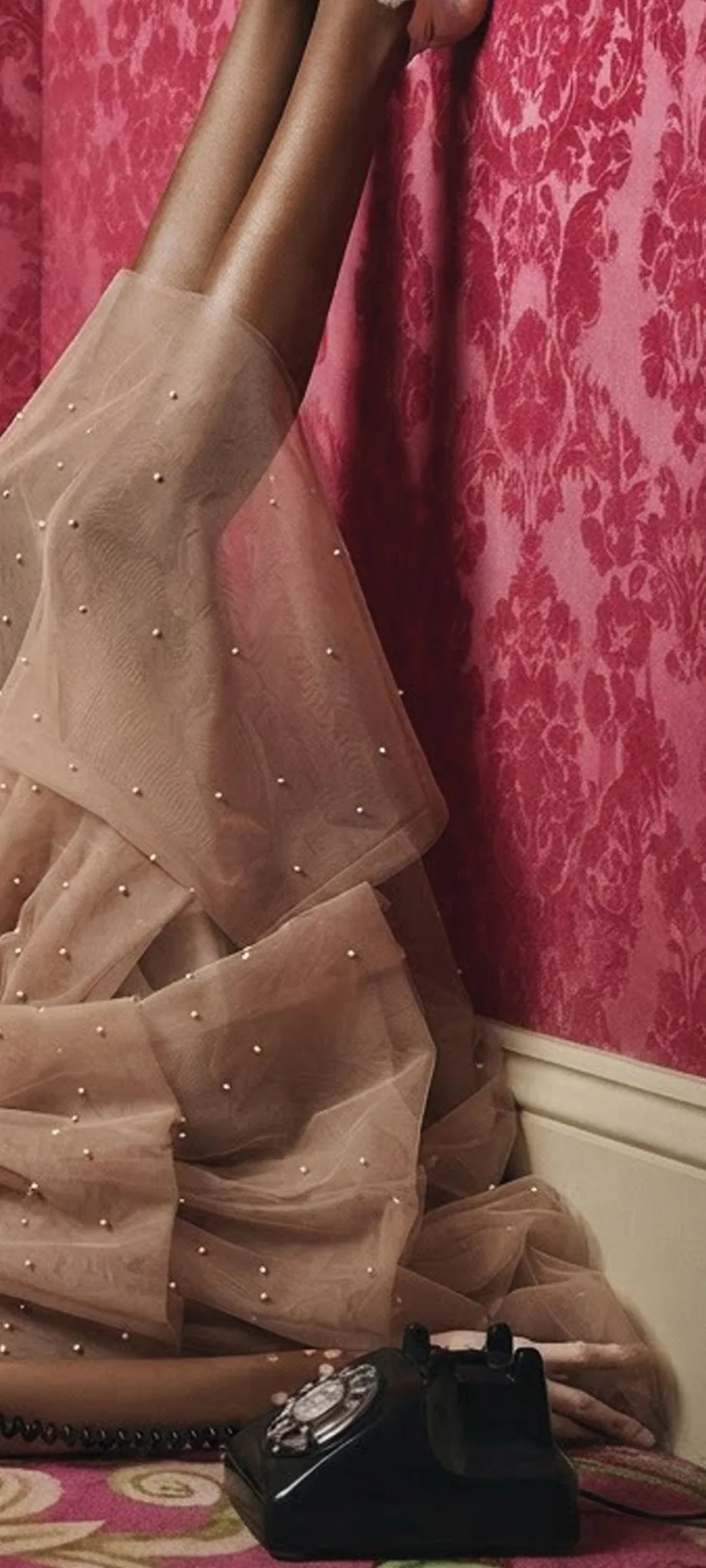 Right-hand part of the same photograph: pearl tulle and the telephone on the carpet