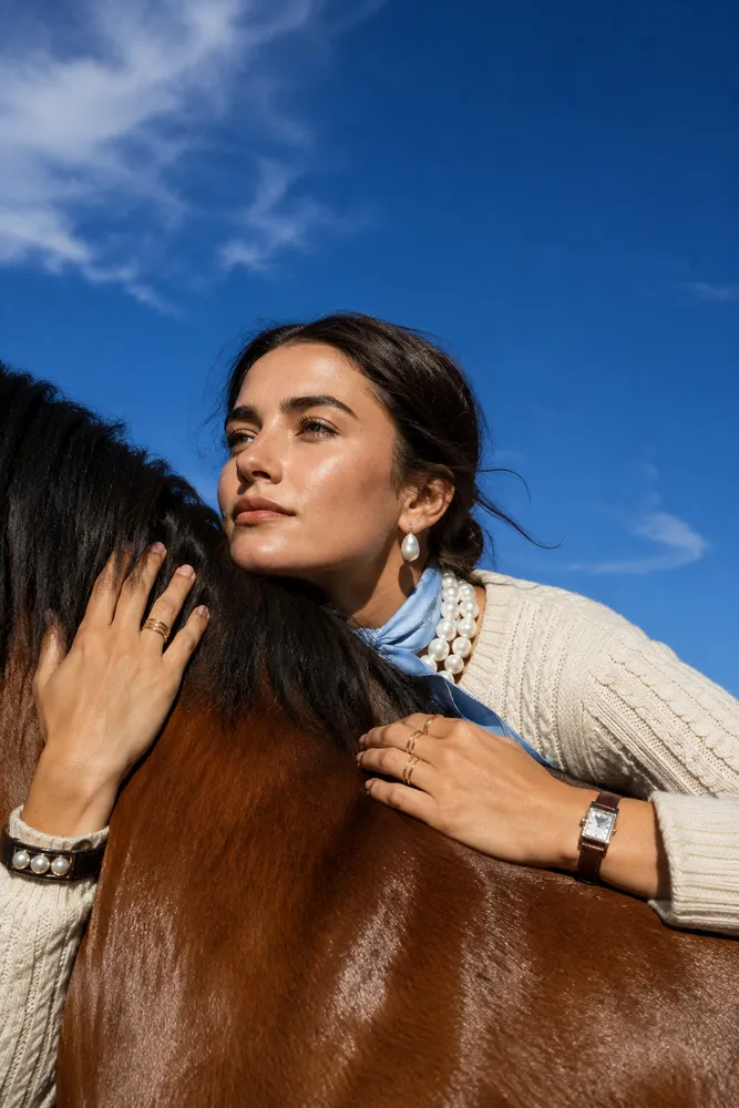 Woman with a horse under blue sky — AI · The o.KI Agency