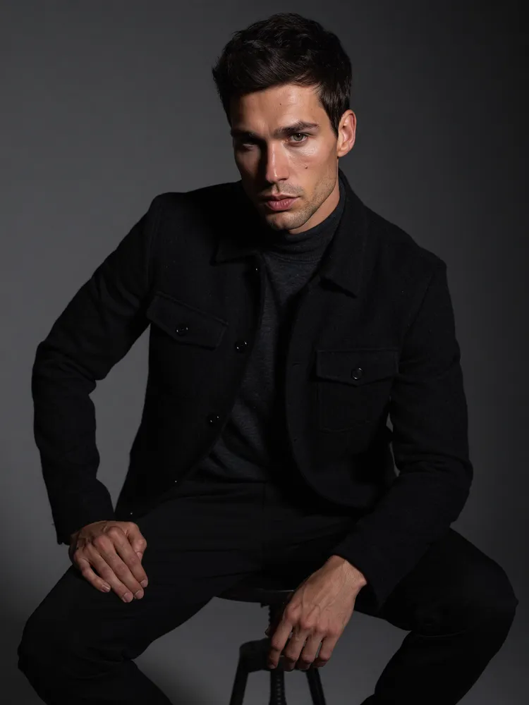 Male model in black suit, studio — AI · The o.KI Agency