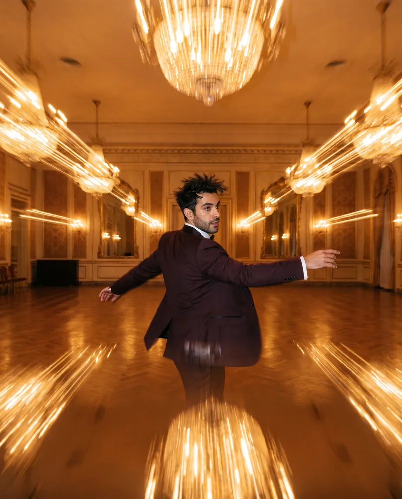 Man in suit dancing in a ballroom — AI · The o.KI Agency
